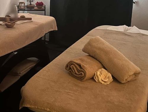 a tranquil massage setup with towels and soft lighting